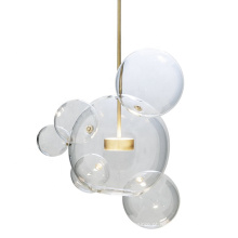Lâmpadas pendentes penduradas em bola de vidro redondo transparente com corpo dourado transparente para sala de estar